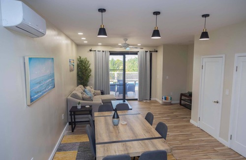 Leeward Settlement Apartment | Poolside Escape with Private Balconies, Near Beach