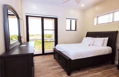 Leeward Settlement Apartment | Poolside Escape with Private Balconies, Near Beach
